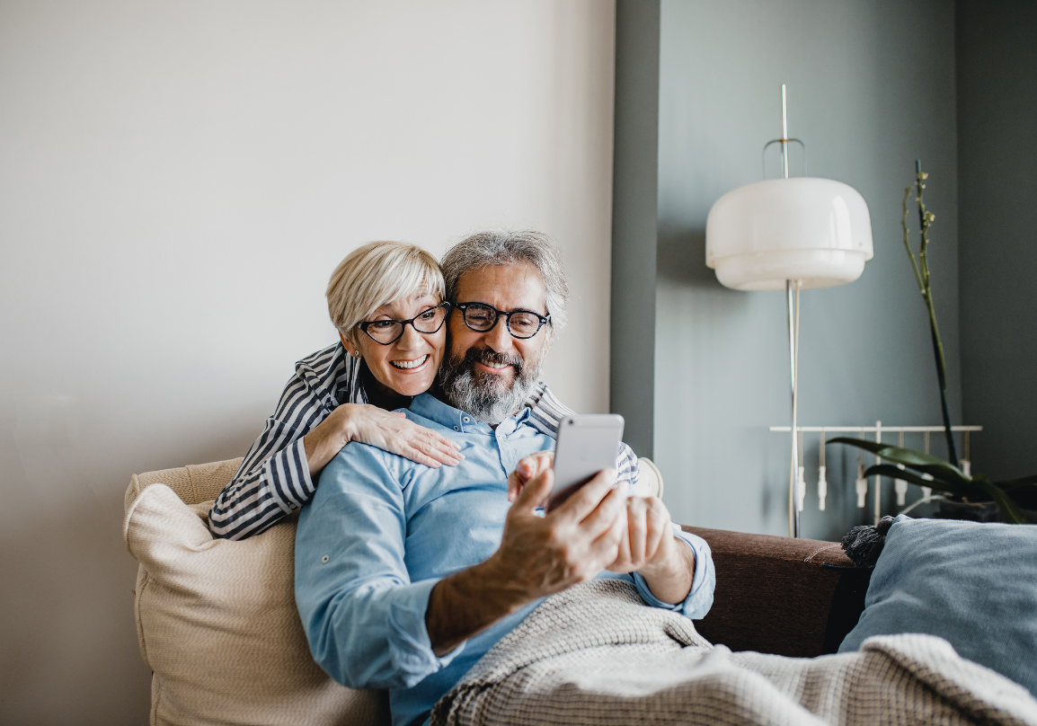 A retired couple talking together at home
